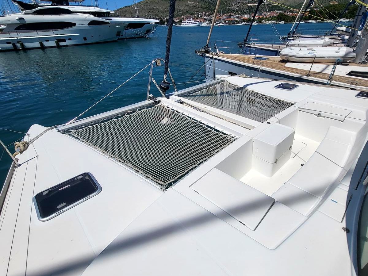 Foredeck and trampolines on Chardonnay with blue water
